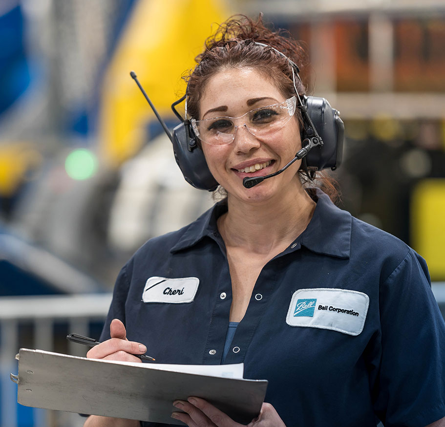 Smiling factory worker performing a safety check