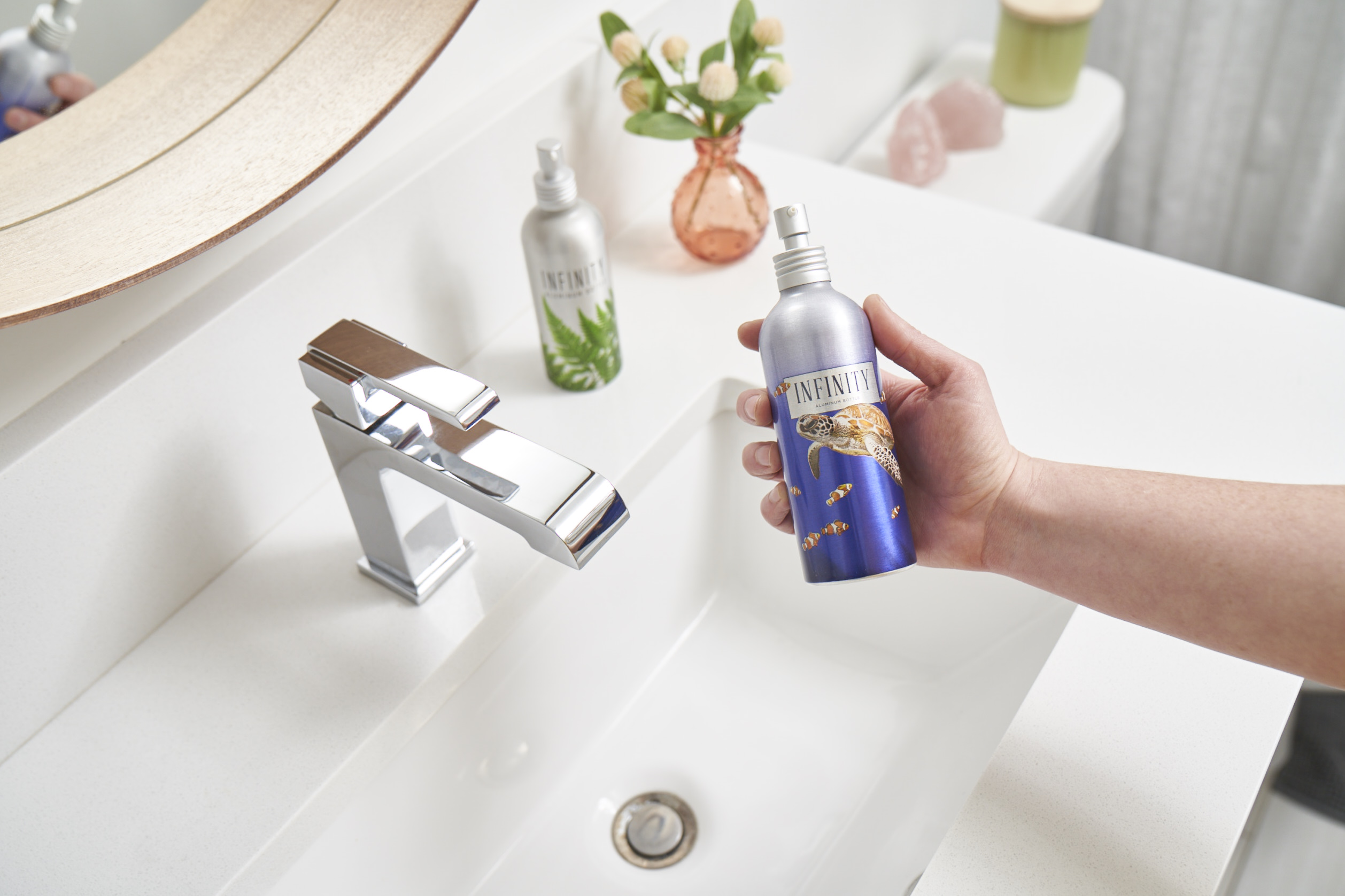 bathroom sink with aluminum bottle in hand